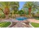 Beautiful water feature with custom tile work, mature trees, and desert landscaping in a private backyard setting at 8825 Rozetta Ct, Las Vegas, NV 89134