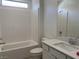 Clean, bright bathroom with tub and shower combination, white cabinets, and tile surround at 901 Heritage Bend Dr, Las Vegas, NV 89138