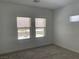 Bright bedroom with neutral carpet, white walls, and natural light from two large windows at 901 Heritage Bend Dr, Las Vegas, NV 89138