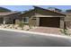 Attractive home with desert landscaping, brick paved driveway and a convenient two-car garage at 901 Heritage Bend Dr, Las Vegas, NV 89138