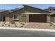 Charming single-story home with desert landscaping and a two-car garage at 901 Heritage Bend Dr, Las Vegas, NV 89138