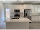 Stylish kitchen boasts a large island, white cabinets, and stainless steel appliances at 901 Heritage Bend Dr, Las Vegas, NV 89138