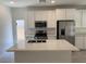 Bright kitchen with white cabinets, stainless steel appliances, island and access to the outdoor space at 901 Heritage Bend Dr, Las Vegas, NV 89138