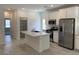 Spacious kitchen featuring white cabinets, stainless steel appliances and a center island with quartz countertops at 901 Heritage Bend Dr, Las Vegas, NV 89138