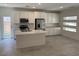 Modern kitchen features white cabinets, stainless steel appliances, and a center island with quartz countertops at 901 Heritage Bend Dr, Las Vegas, NV 89138