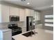 Close-up of kitchen with white cabinets, stainless steel appliances, and quartz countertops at 901 Heritage Bend Dr, Las Vegas, NV 89138