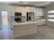 Modern kitchen features white cabinets, stainless steel appliances, and a center island with quartz countertops at 901 Heritage Bend Dr, Las Vegas, NV 89138