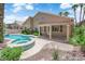 Backyard featuring a pool, spa, covered patio, and desert landscaping at 9500 Catalina Cove Cir, Las Vegas, NV 89147