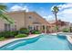 Lush backyard with pool, spa, covered patio, and desert landscaping at 9500 Catalina Cove Cir, Las Vegas, NV 89147
