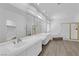 Bright bathroom with double sinks, large mirror, and a separate shower and tub at 9500 Catalina Cove Cir, Las Vegas, NV 89147