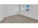Bright bedroom with neutral carpet, white walls, and plantation shutters at 9500 Catalina Cove Cir, Las Vegas, NV 89147