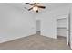 Clean, bright bedroom with carpet, white walls, ceiling fan and closet in a modern home at 9500 Catalina Cove Cir, Las Vegas, NV 89147