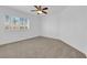 Bright bedroom with neutral carpet, white walls, ceiling fan, and plantation shutters at 9500 Catalina Cove Cir, Las Vegas, NV 89147