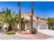 Beautiful two-story house with desert landscaping including palm trees and gravel at 9500 Catalina Cove Cir, Las Vegas, NV 89147