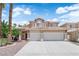 Charming two-story home with a well-manicured lawn, palm trees, and a three car garage at 9500 Catalina Cove Cir, Las Vegas, NV 89147