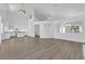 Bright living room with wood floors, white trim, and soaring ceilings offers an open floor plan at 9500 Catalina Cove Cir, Las Vegas, NV 89147