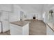 Open floor plan connecting kitchen and living room with white cabinetry and fireplace at 9500 Catalina Cove Cir, Las Vegas, NV 89147