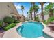 Private backyard oasis with a sparkling pool, spa, and lush tropical landscaping at 9500 Catalina Cove Cir, Las Vegas, NV 89147
