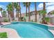 Sparkling pool and spa surrounded by palm trees and a block fence offering privacy at 9500 Catalina Cove Cir, Las Vegas, NV 89147