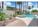 Backyard pool and spa with lush landscaping creating a private oasis at 9500 Catalina Cove Cir, Las Vegas, NV 89147