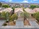 Aerial view of a tan two-story home with desert landscaping in a residential neighborhood at 9709 Fast Elk St, Las Vegas, NV 89143