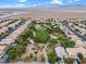 Aerial view of a neighborhood with a large park and desert landscape in the distance at 9709 Fast Elk St, Las Vegas, NV 89143