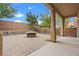 Beautiful backyard area with patio, stone fire pit, and block wall at 9709 Fast Elk St, Las Vegas, NV 89143