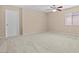 Bright bedroom with carpet, neutral walls, and a ceiling fan at 9709 Fast Elk St, Las Vegas, NV 89143