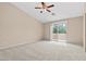 Large bedroom with sliding glass doors, ceiling fan and neutral walls at 9709 Fast Elk St, Las Vegas, NV 89143