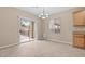 Bright dining area with sliding glass door to backyard, neutral walls and flooring, and elegant hanging lighting at 9709 Fast Elk St, Las Vegas, NV 89143
