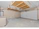 Spacious garage with epoxy flooring, shelving, and a garage door at 9709 Fast Elk St, Las Vegas, NV 89143