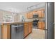 Modern kitchen with stainless steel appliances, island with sink, tile flooring and natural light from sliding glass door at 9709 Fast Elk St, Las Vegas, NV 89143