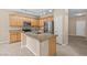 Bright kitchen with stainless steel appliances, wooden cabinetry, and a spacious island, perfect for cooking and entertaining at 9709 Fast Elk St, Las Vegas, NV 89143