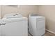 Laundry room with white washer and dryer and neutral walls at 9709 Fast Elk St, Las Vegas, NV 89143