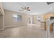 Spacious living area with ample natural light, ceiling fan, neutral flooring, and an open view to the adjacent kitchen and dining spaces at 9709 Fast Elk St, Las Vegas, NV 89143