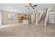 Open-concept living space with kitchen, tile flooring, modern lighting fixtures and a staircase with natural light at 9709 Fast Elk St, Las Vegas, NV 89143