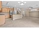 Open concept living room adjacent to a large kitchen and staircase featuring lots of natural light and tile flooring at 9709 Fast Elk St, Las Vegas, NV 89143