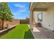 Spacious backyard with a paver patio, artificial turf, and well-manicured landscaping at 10776 Maltese Falcon Ave, Las Vegas, NV 89129