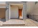 Covered entryway with brick-paved walkway leads to an orange front door with house number at 10776 Maltese Falcon Ave, Las Vegas, NV 89129