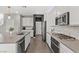 Contemporary kitchen with stainless appliances, gray countertops, and abundant cabinet space at 10776 Maltese Falcon Ave, Las Vegas, NV 89129