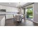 Open kitchen with stainless appliances, quartz countertops, and dining area at 10776 Maltese Falcon Ave, Las Vegas, NV 89129