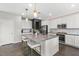 Bright kitchen features a large island with seating, stainless appliances, and ample white cabinetry at 10776 Maltese Falcon Ave, Las Vegas, NV 89129