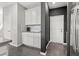 Bright kitchen with white cabinetry and black accent wall near doorway at 10776 Maltese Falcon Ave, Las Vegas, NV 89129