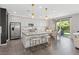 Modern kitchen boasts stainless steel appliances, white cabinetry, and a large island with seating at 10776 Maltese Falcon Ave, Las Vegas, NV 89129