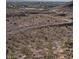 Desert landscape with scrub vegetation and winding dirt roads, city visible in the background at 10776 Maltese Falcon Ave, Las Vegas, NV 89129