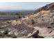 Panoramic shot showcasing desert terrain, rocky hillside, and urban skyline on the horizon at 10776 Maltese Falcon Ave, Las Vegas, NV 89129