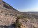 Desert hillside under a clear sky with scattered scrub, leading to a distant horizon at 10776 Maltese Falcon Ave, Las Vegas, NV 89129