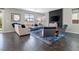 Bright living room with modern furniture, stylish rug, and sliding glass door to the back yard at 10776 Maltese Falcon Ave, Las Vegas, NV 89129