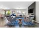 Bright living room with modern furniture, stylish rug, and large windows at 10776 Maltese Falcon Ave, Las Vegas, NV 89129