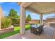 Charming covered patio with dining table and outdoor seating at 10776 Maltese Falcon Ave, Las Vegas, NV 89129